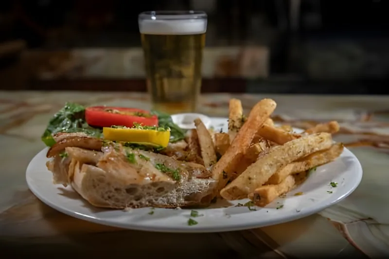 A panini with herbed fries and a beer